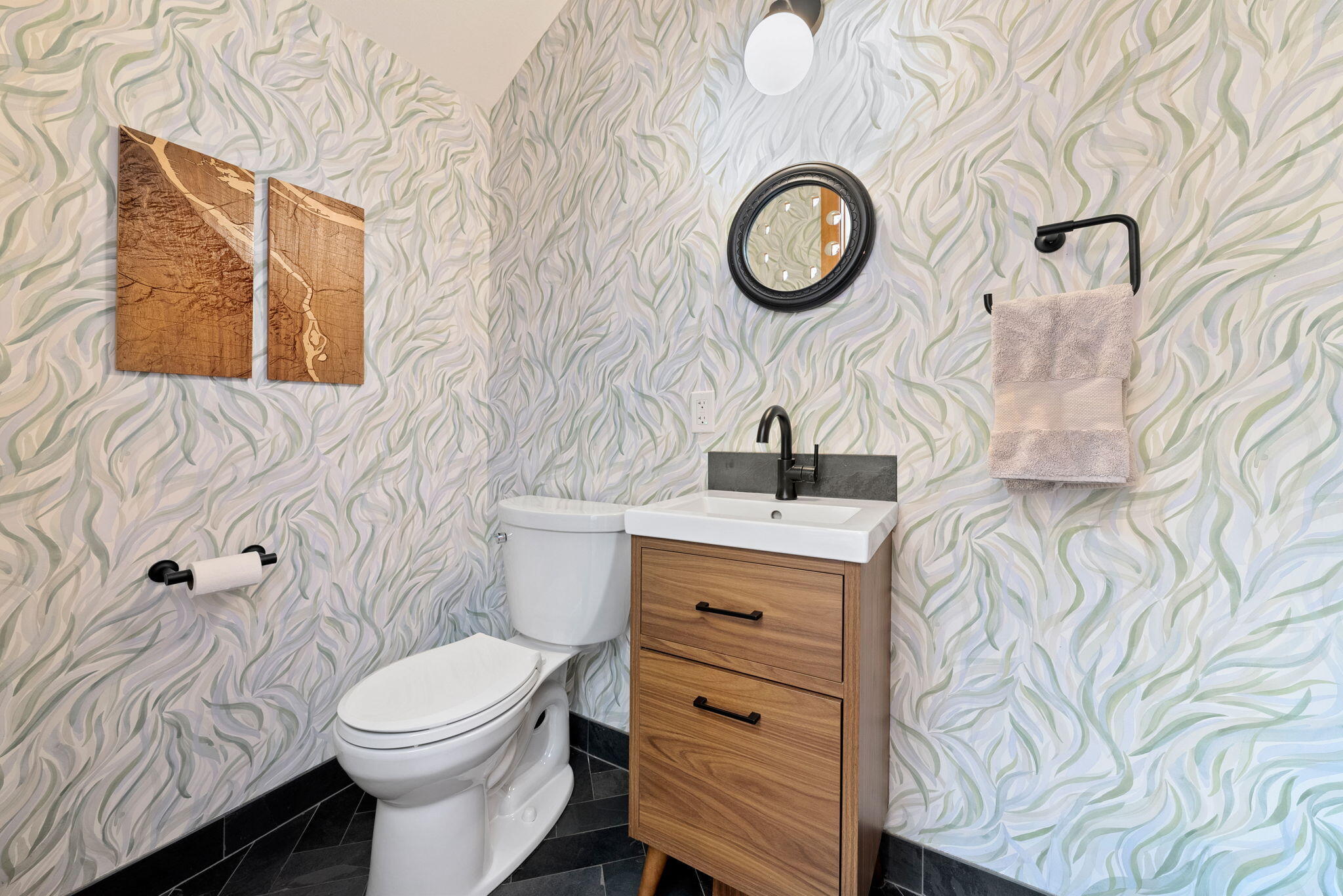 65345 Tweed Road Bend, OR 97703 - Photo 32 of 90 a bathroom with a toilet sink and mirror