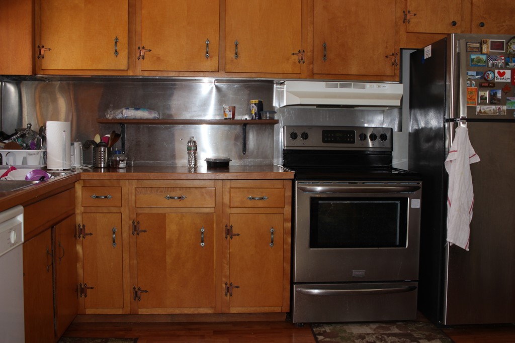 1333 Bay Road Sharon, MA 02067 - Photo 6 of 16 a kitchen with stainless steel appliances granite countertop a stove and a refrigerator