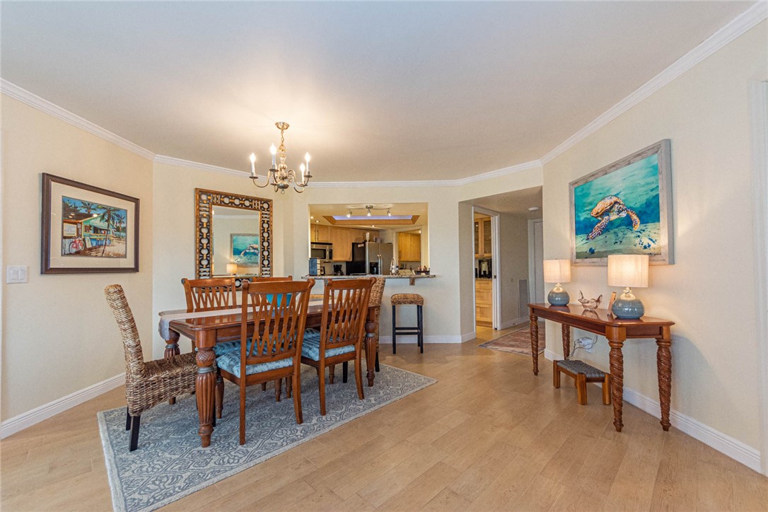 1850 Bay Road, Unit 3G Vero Beach, FL 32963 - Photo 15 of 36 a view of a dining room with furniture a chandelier and wooden floor