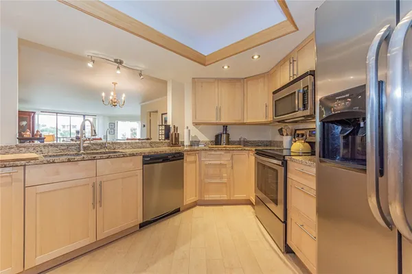 a kitchen with white cabinets and sink