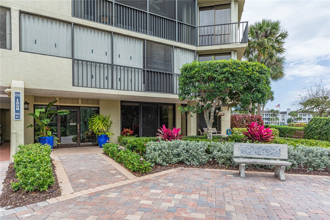 1850 Bay Road, Unit 3G Vero Beach, FL 32963 - Photo 2 of 36 a front view of a building with flowers