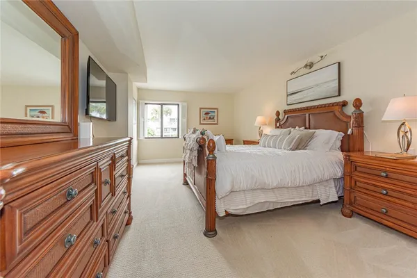 a bedroom with furniture and a flat screen tv