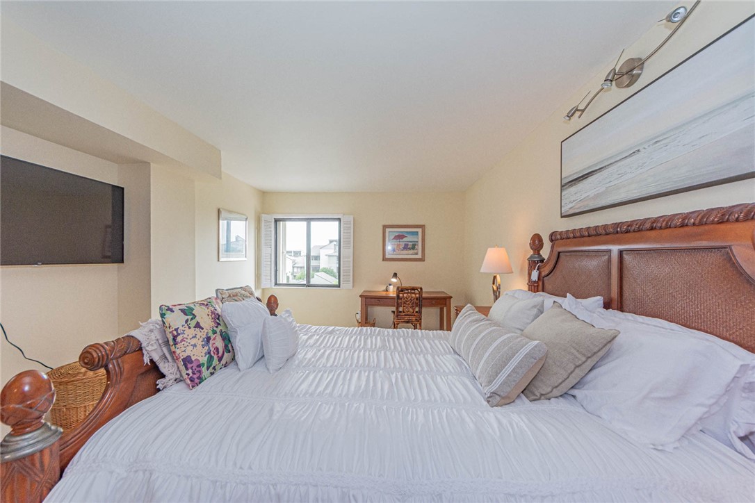 1850 Bay Road, Unit 3G Vero Beach, FL 32963 - Photo 25 of 36 a bedroom with a bed and flat screen tv