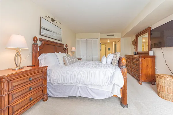 a spacious bedroom with a bed and window