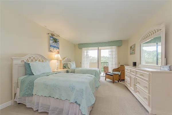a bed room with a bed and a large window