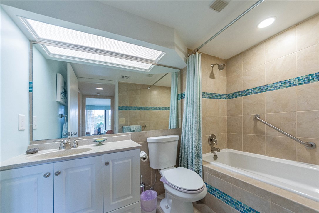 1850 Bay Road, Unit 3G Vero Beach, FL 32963 - Photo 30 of 36 a bathroom with a granite countertop toilet a sink and a bathtub