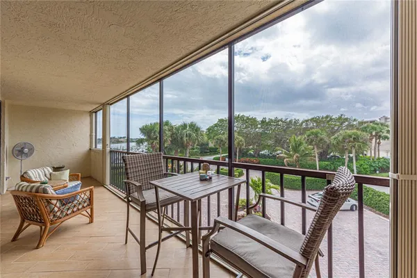 a view of a chairs and table in the balcony