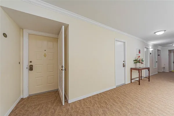 a view of a room that has a bed and a table in it
