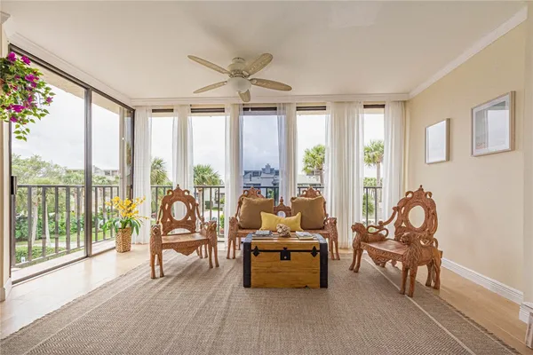 a living room with furniture and floor to ceiling windows
