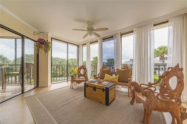 a living room with furniture and floor to ceiling windows