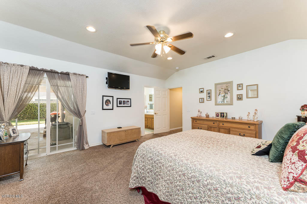 4243 Apricot Road Simi Valley, CA 93063 - Photo 14 of 33 a bedroom with a bed and a chandelier