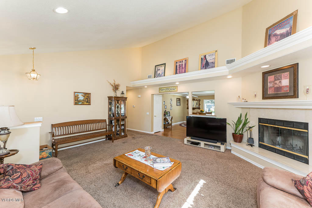 4243 Apricot Road Simi Valley, CA 93063 - Photo 8 of 33 a living room with furniture a fireplace and a flat screen tv