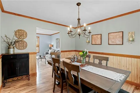 a view of a dining room with furniture wooden floor and a chandelier