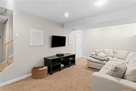 a living room with furniture and a night stand