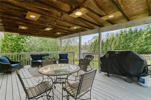 a view of a patio with couches table and chairs and potted plants