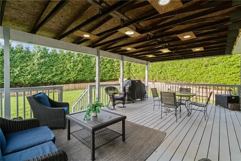 a backyard of a house with table and chairs