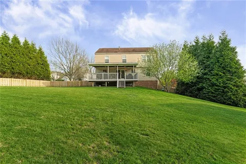 a view of a house with a backyard