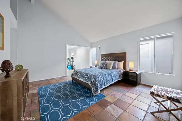 a bedroom with a bed and a window in it