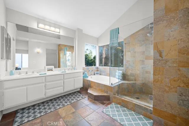 a large bathroom with a glass door shower and sink