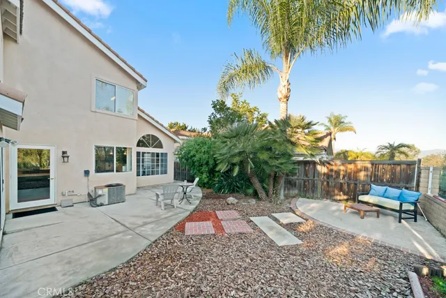 a view of a house with backyard and sitting area
