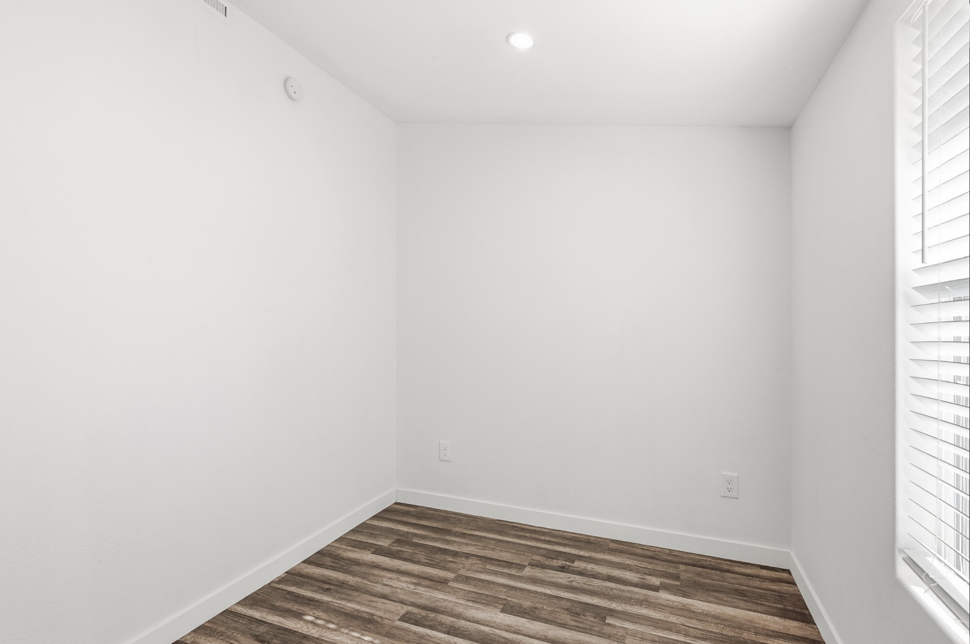 108 Irene Street Elgin, TX 78621 - Photo 22 of 29 Empty room with dark wood-type flooring and recessed lighting