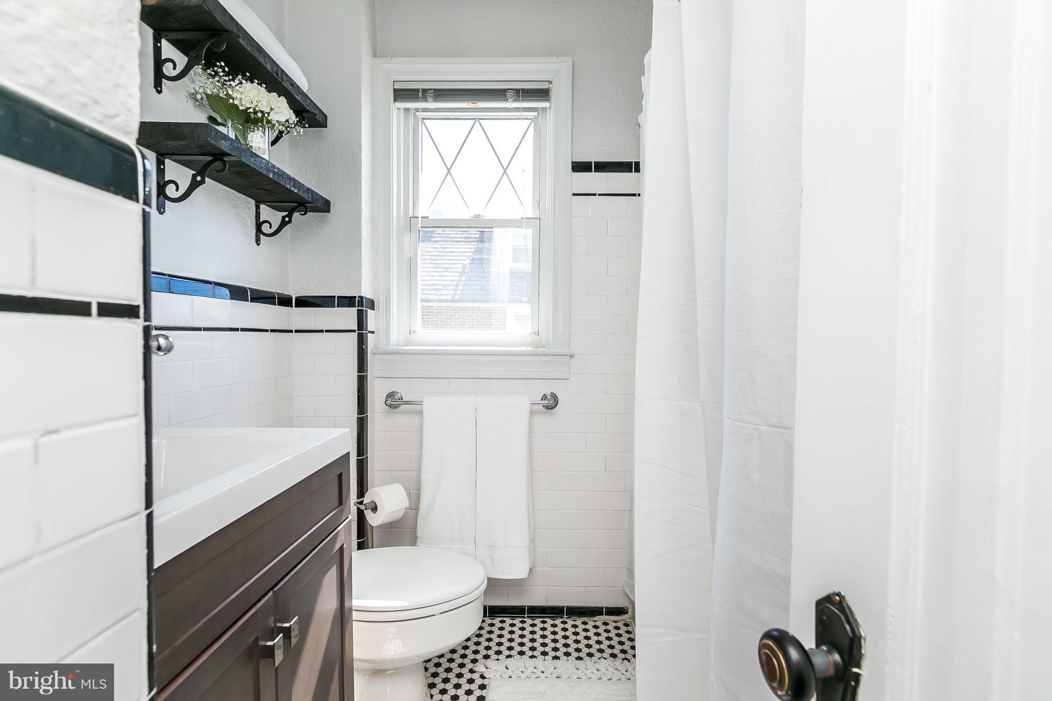 419 Hopkins Road Baltimore, MD 21212 - Photo 17 of 30 a bathroom with a toilet a sink and a window