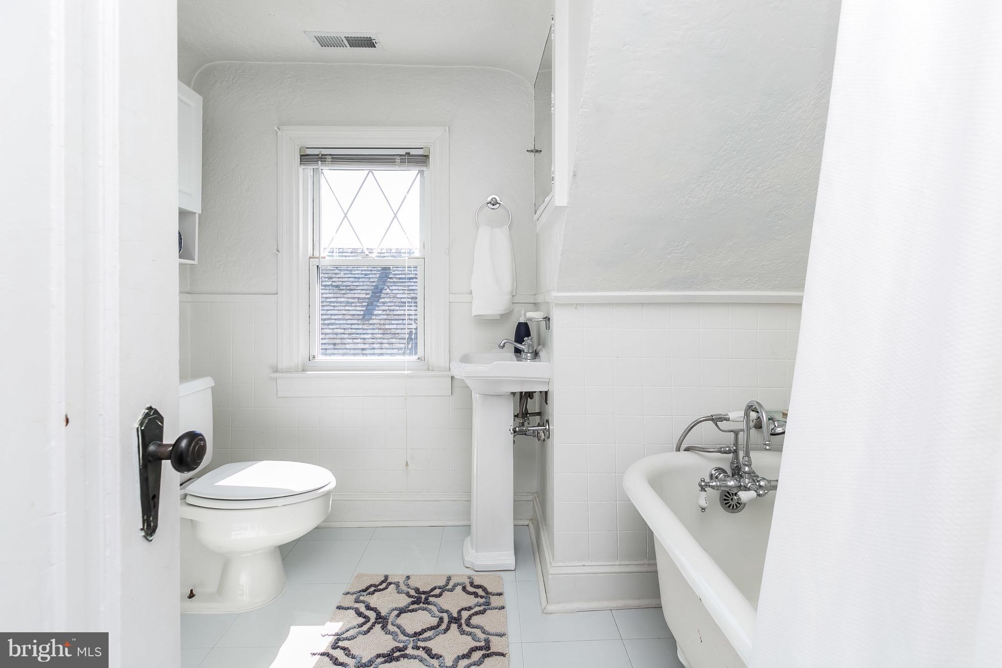 419 Hopkins Road Baltimore, MD 21212 - Photo 23 of 30 a bathroom with a sink a toilet and shower
