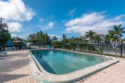 a swimming pool with outdoor seating and plants