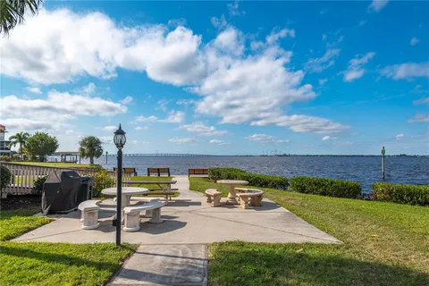 an aerial view of a house with a yard pool outdoor seating yard and lake view