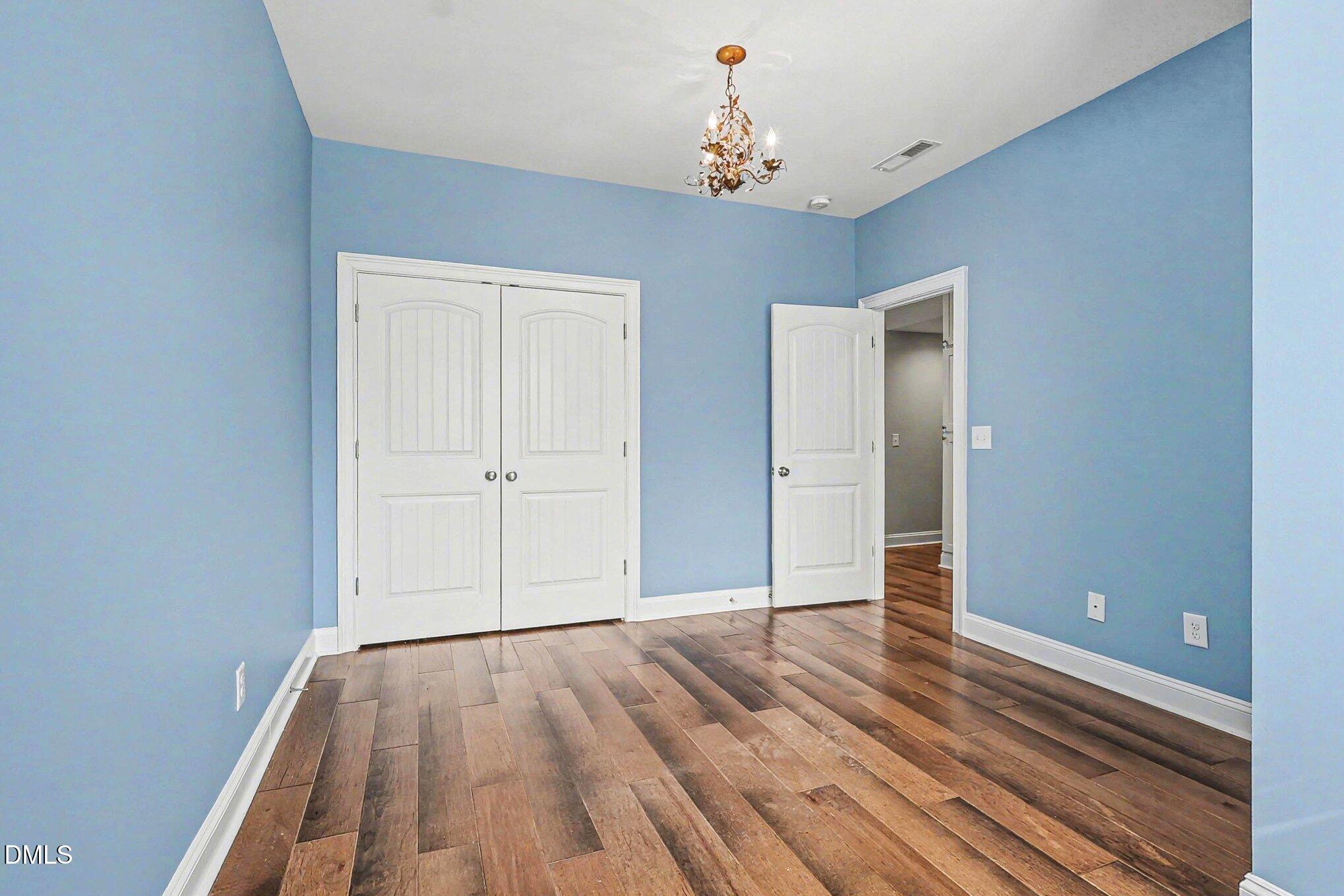 653 Fallon Grove Way Raleigh, NC 27608 - Photo 16 of 38 a view of empty room with wooden floor