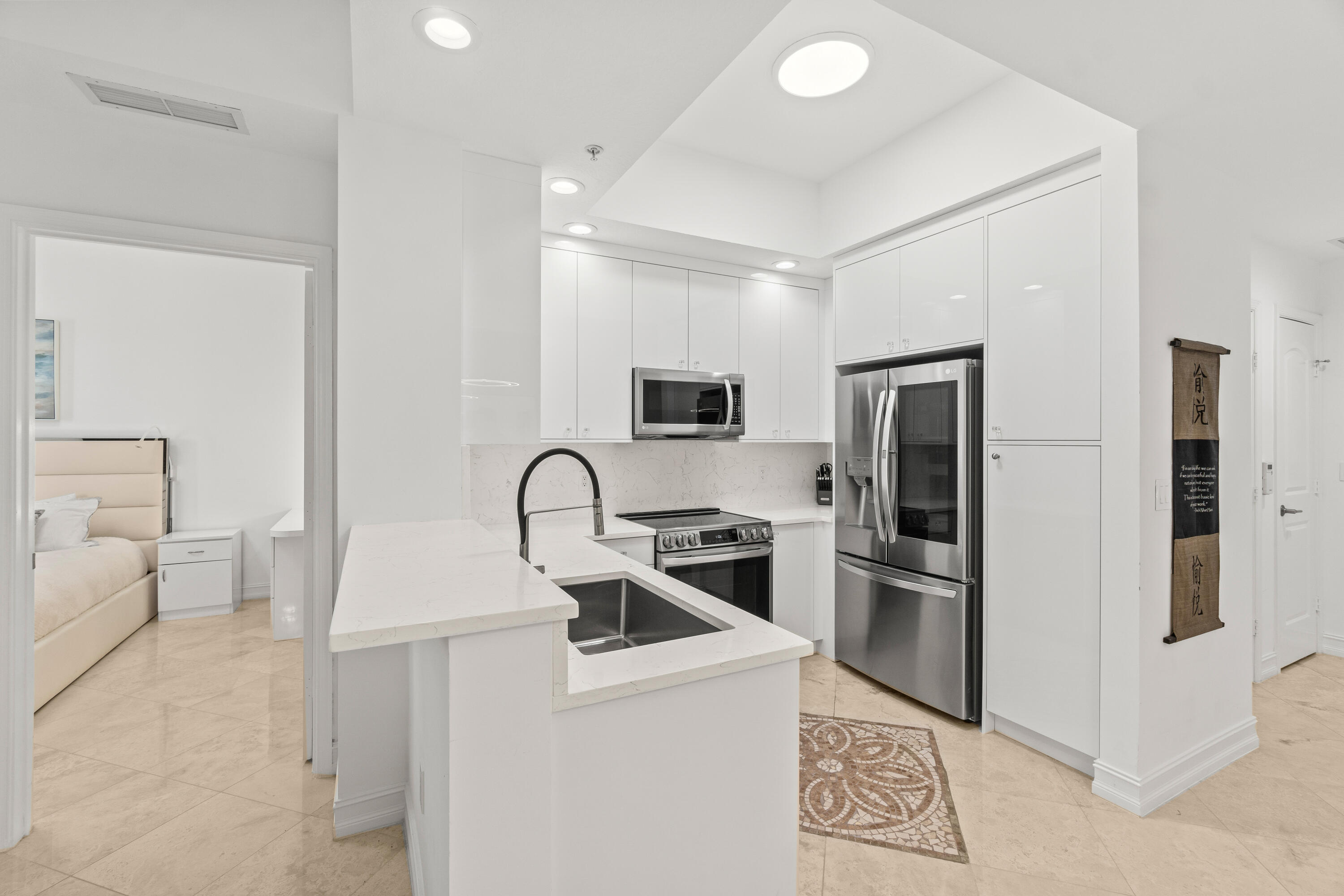 a kitchen with a sink appliances and cabinets