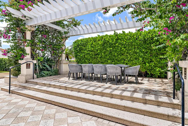 a view of house with backyard and sitting area