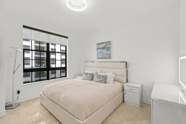 a bedroom with a large bed and a window