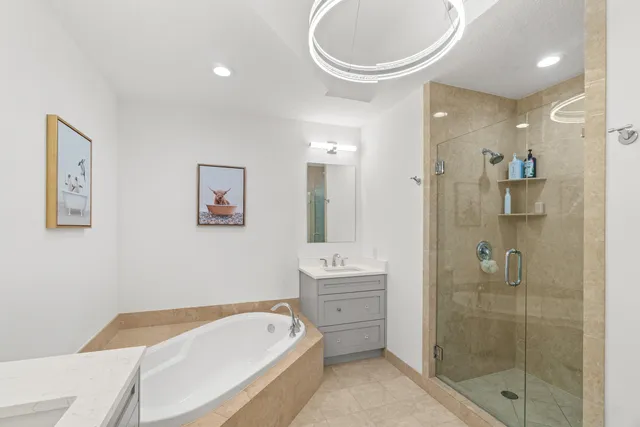 a bathroom with a tub a toilet and a shower