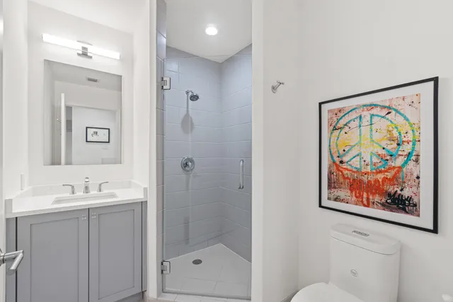 a bathroom with a painting on the wall and a shower