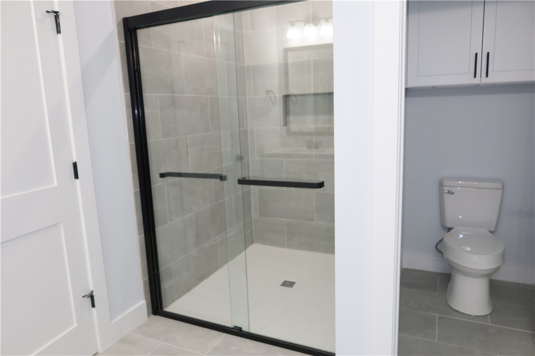 2014 Reagan Court Bryan, TX 77802 - Photo 15 of 22 a bathroom with a toilet and a shower