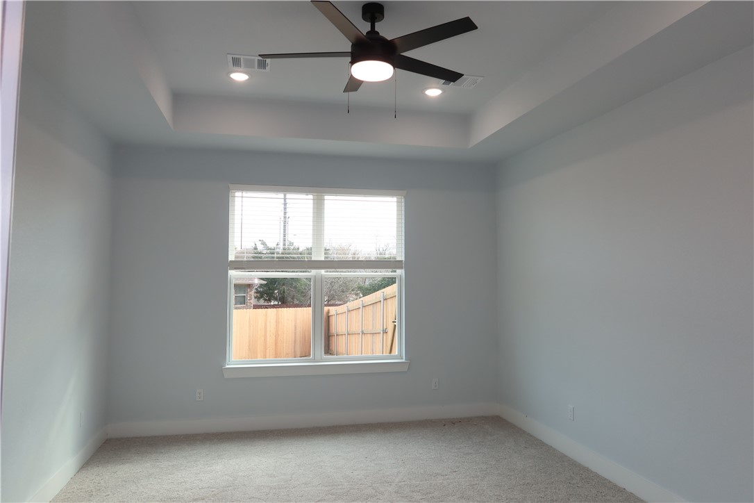 2014 Reagan Court Bryan, TX 77802 - Photo 16 of 22 an empty room with a window and a fan