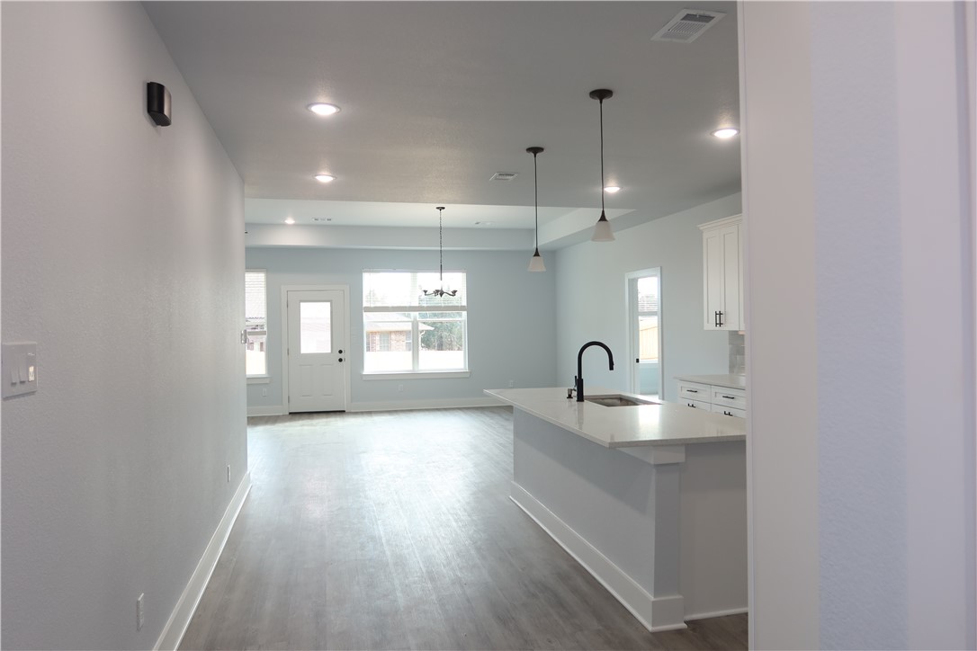2014 Reagan Court Bryan, TX 77802 - Photo 6 of 22 a kitchen with granite countertop cabinets a sink and appliances