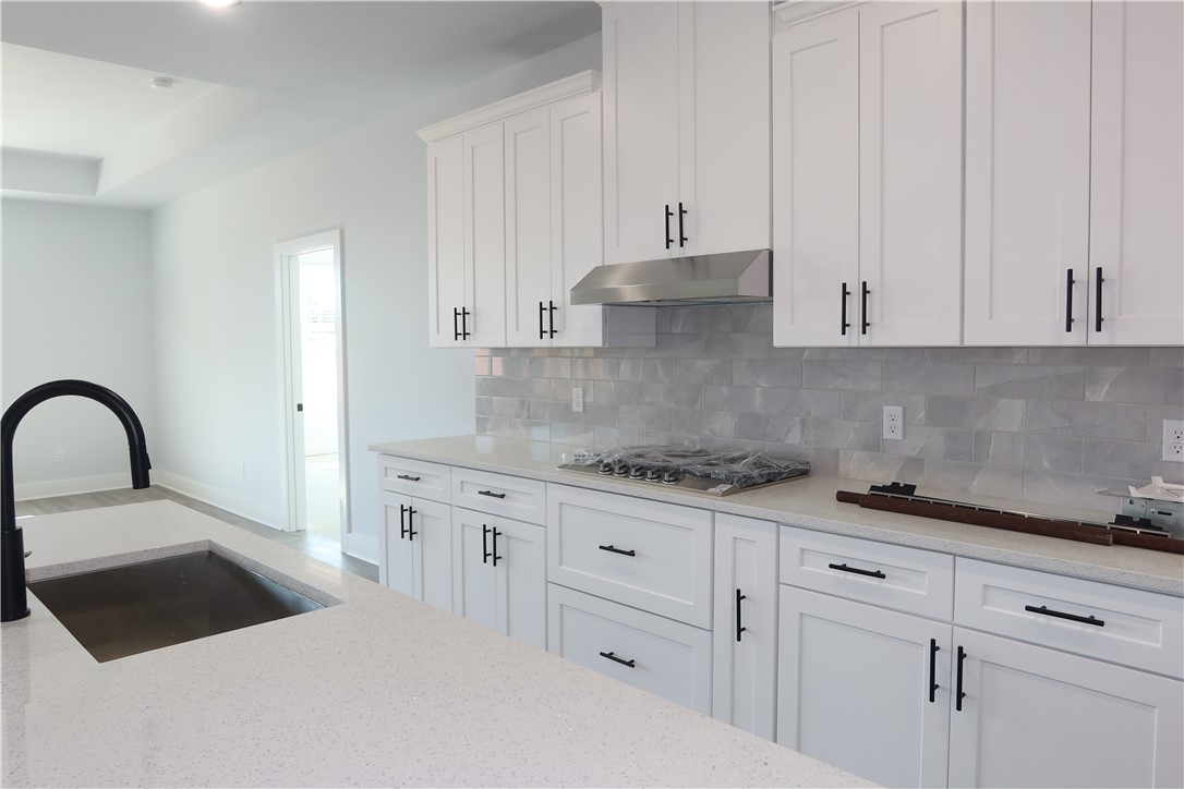 2014 Reagan Court Bryan, TX 77802 - Photo 7 of 22 a kitchen with granite countertop white cabinets and a sink