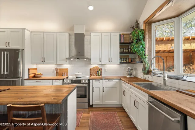 a view of staircase with a large window and wooden floor
