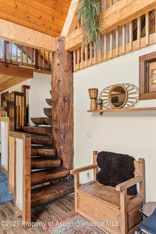 a bathroom with a double vanity sink a toilet a mirror and shower