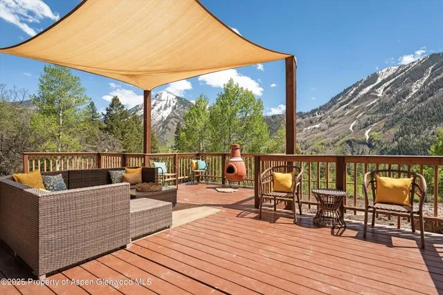 a view of mountains in middle of the green field