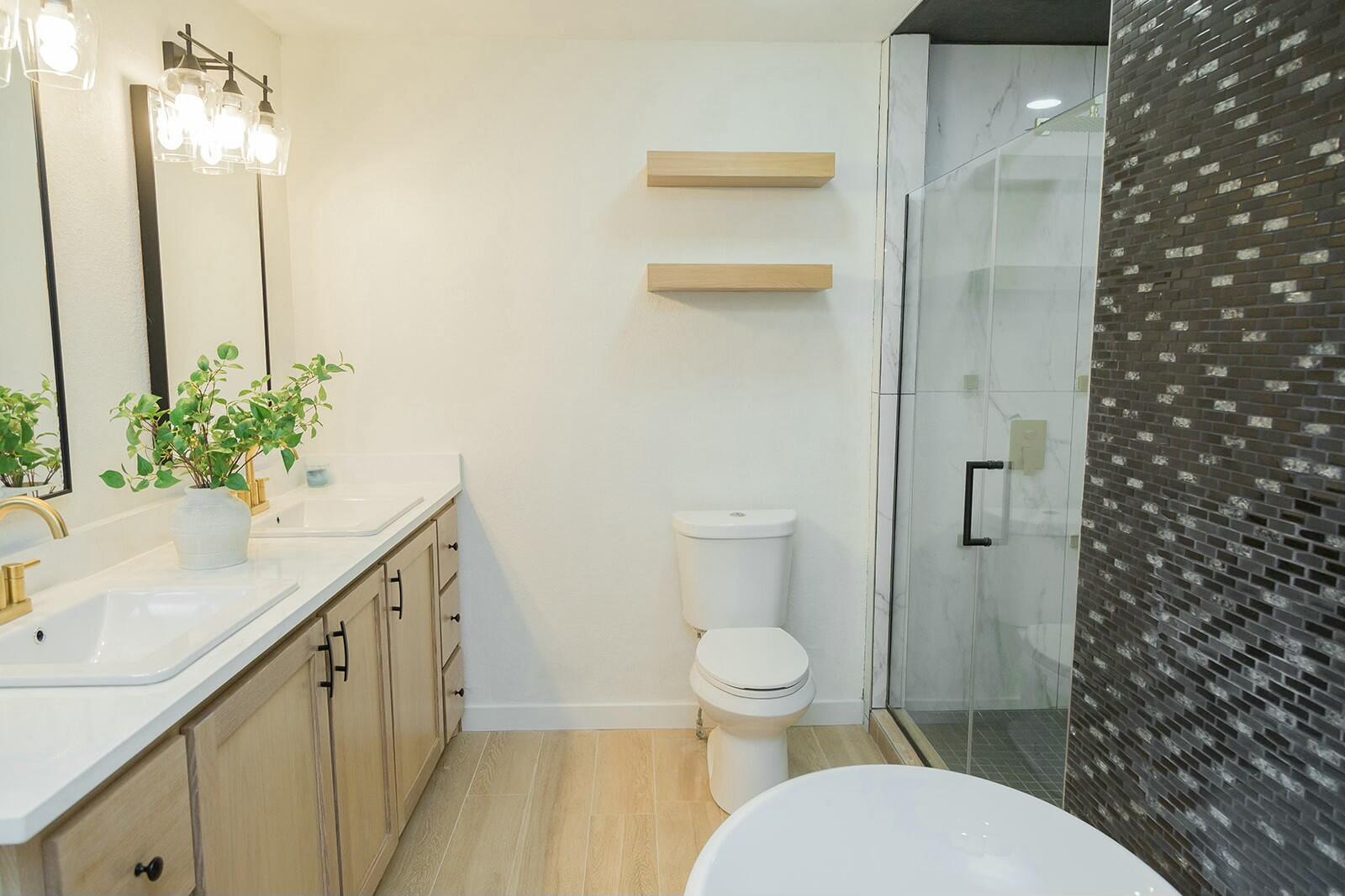 2802 West 20th Plainview, TX 79072 - Photo 30 of 50 a bathroom with a granite countertop sink toilet and shower