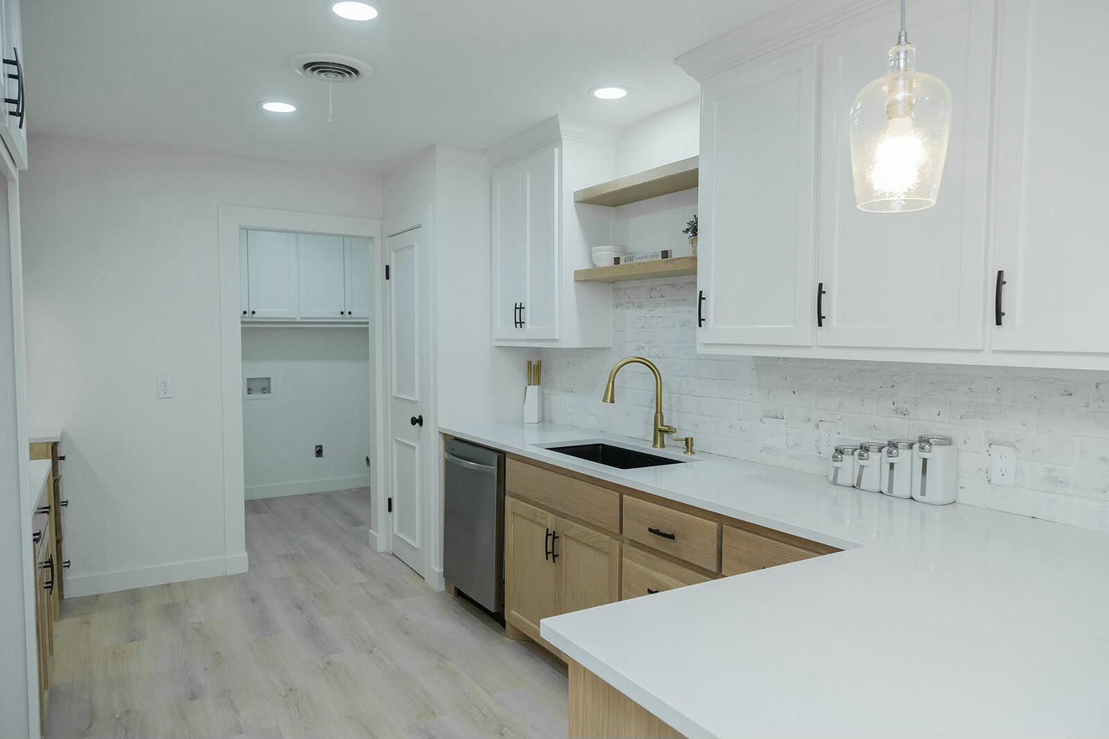 2802 West 20th Plainview, TX 79072 - Photo 10 of 50 a kitchen with white cabinets a sink a stove and refrigerator