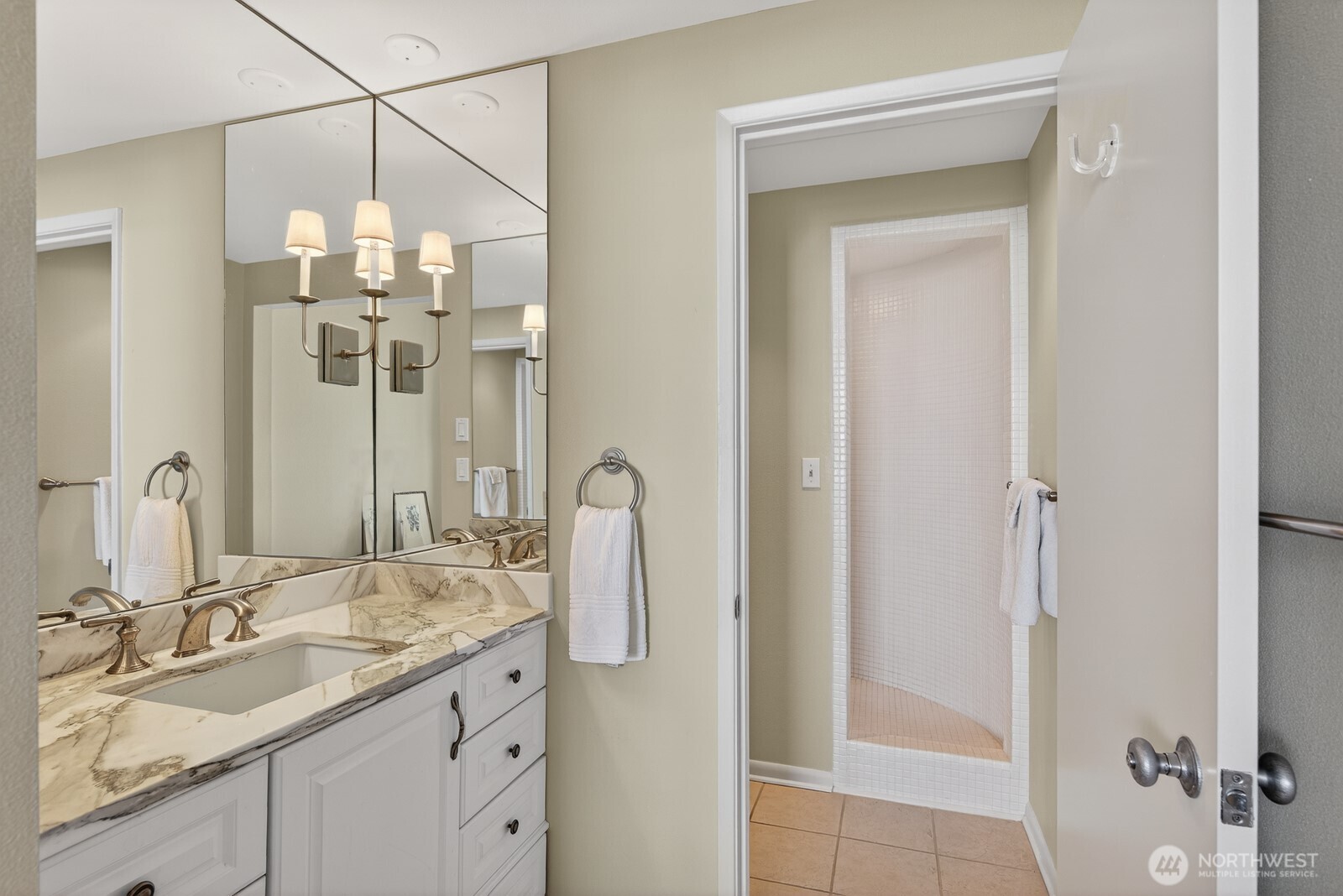 610 Front Street, Unit 302 Mukilteo, WA 98275 - Photo 22 of 40 a bathroom with a granite countertop sink a mirror and a shower