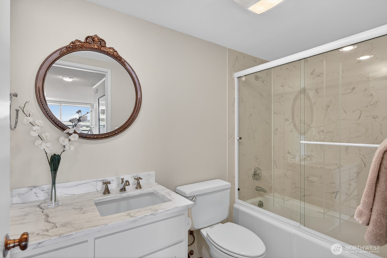 610 Front Street, Unit 302 Mukilteo, WA 98275 - Photo 27 of 40 a bathroom with a toilet a sink and a mirror