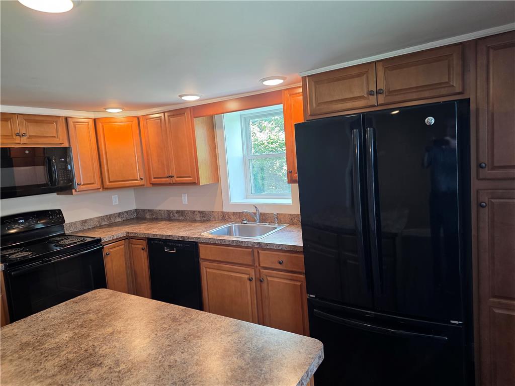 5166 Springmill Road Whitehall, PA 18052 - Photo 11 of 29 A well-appointed kitchen features ample cabinetry, modern appliances, and a convenient island with integrated sink.