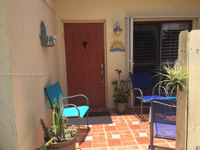 6783 Bridlewood Court, Unit 6783 Boca Raton, FL 33433 - Photo 1 of 56 a potted plant sitting on a table in front of a house