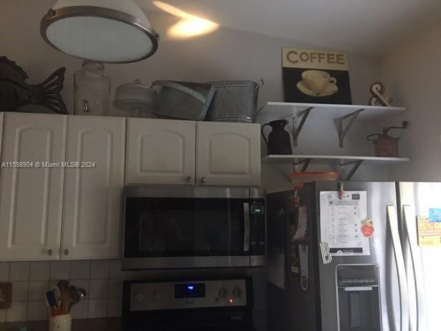 6783 Bridlewood Court, Unit 6783 Boca Raton, FL 33433 - Photo 11 of 56 a kitchen with a cabinets and appliances