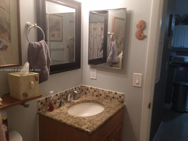 6783 Bridlewood Court, Unit 6783 Boca Raton, FL 33433 - Photo 25 of 56 a bathroom with a granite countertop sink and a mirror